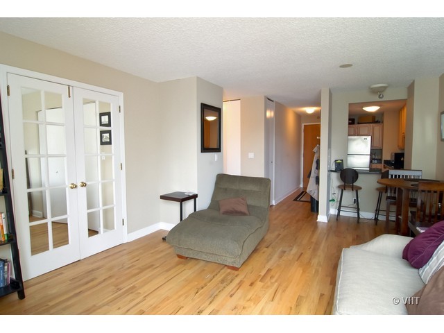 1122 North Clark Street, Unit 2509 Chicago, IL 60610 - Photo 3 of 11 a living room with furniture and a wooden floor