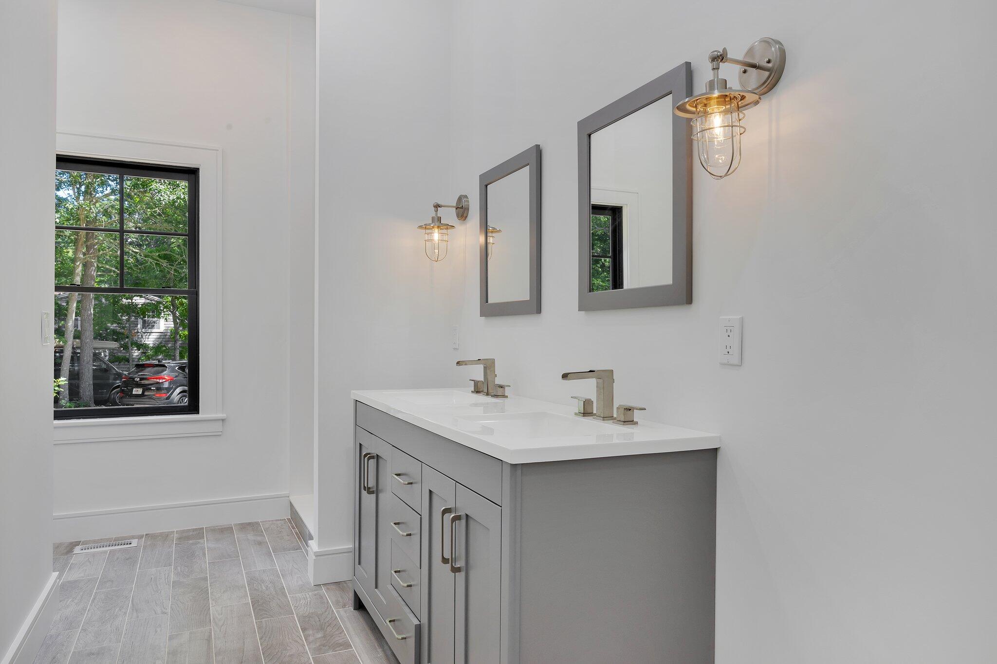 72 5 Corners Road Centerville, MA 02632 - Photo 19 of 48 a bathroom with a sink a mirror and a window