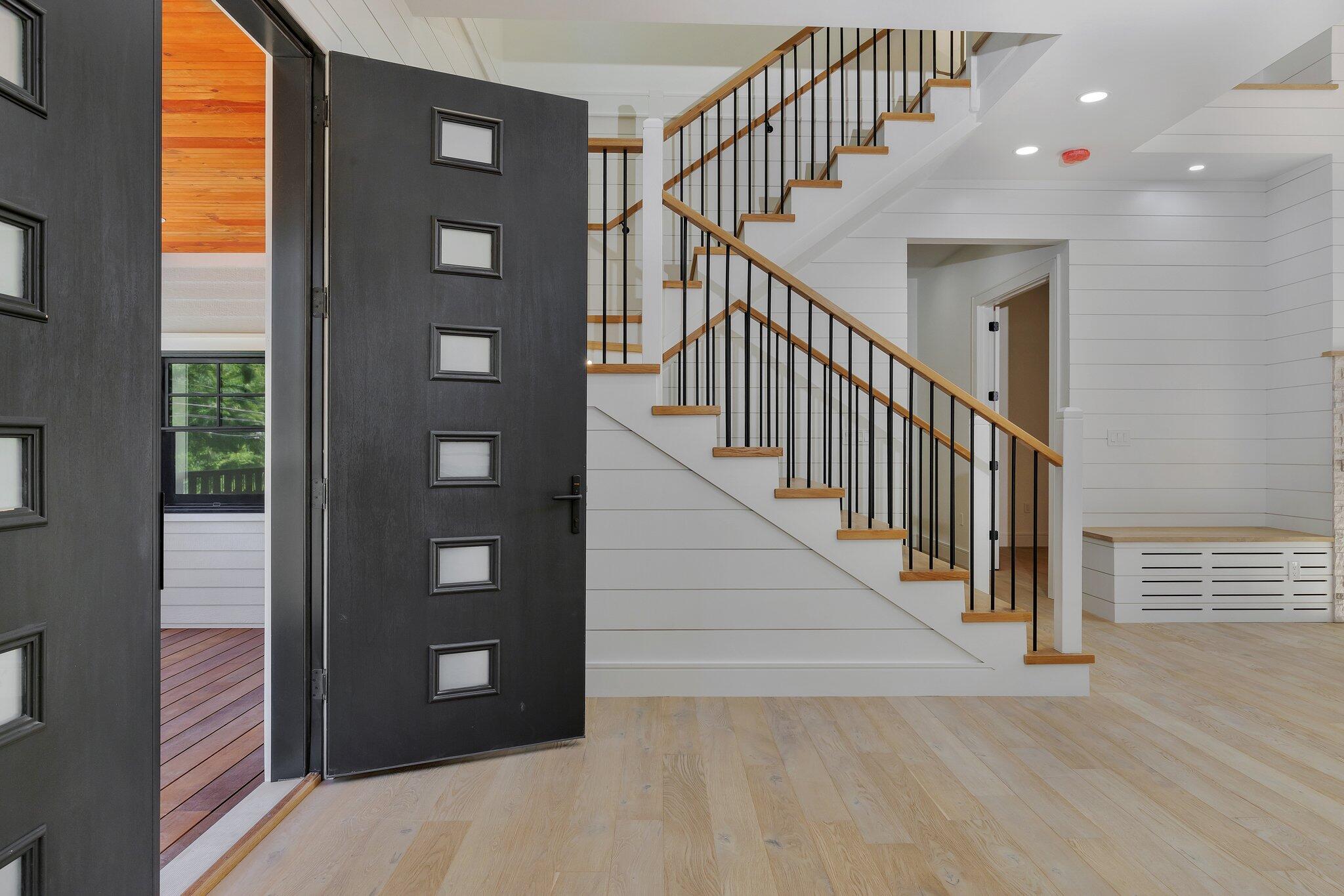 72 5 Corners Road Centerville, MA 02632 - Photo 2 of 48 a view of staircase with lots of frames on wall and windows