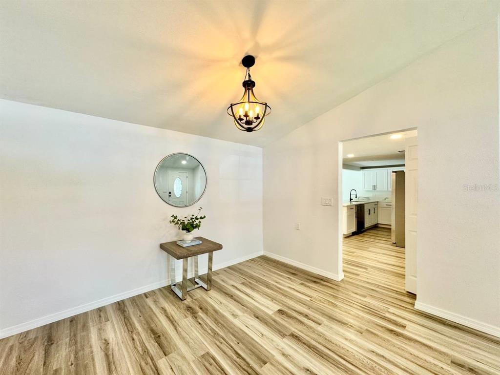 4282 Rudder Way New Port Richey, FL 34652 - Photo 10 of 34 a view of a room with wooden floor and ceiling fan