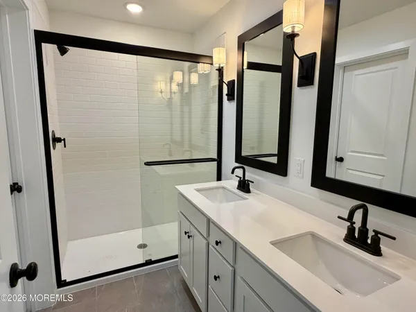 a bathroom with a double vanity sink and mirror