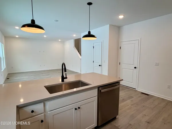 a kitchen with a sink and chandelier