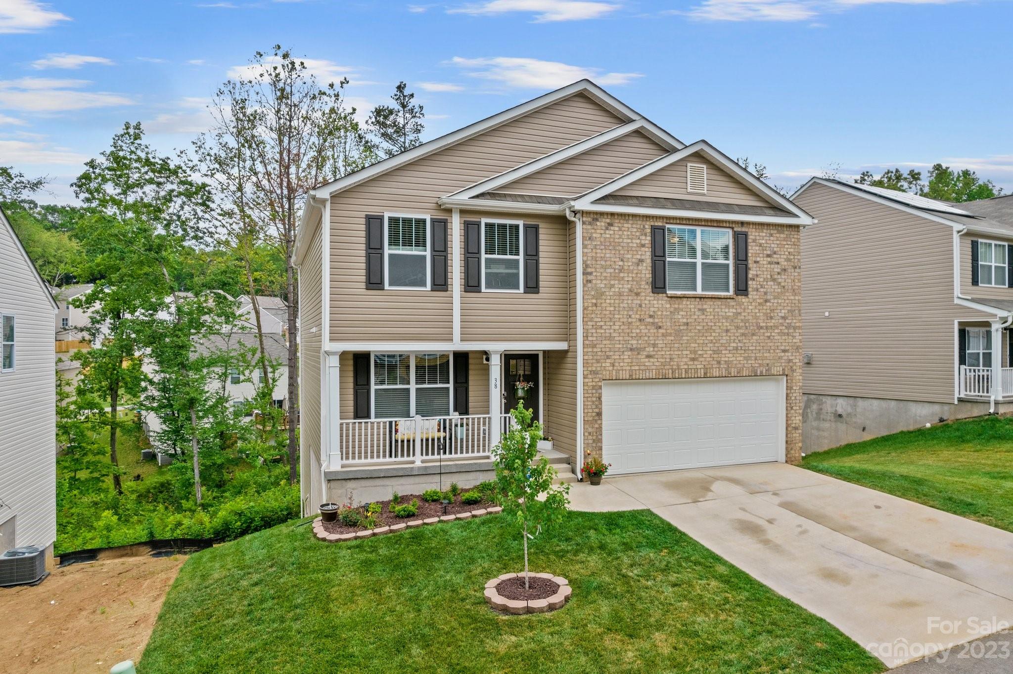 38 Hamrick Drive Candler, NC 28715 - Photo 1 of 37 a front view of a house with a yard and garage