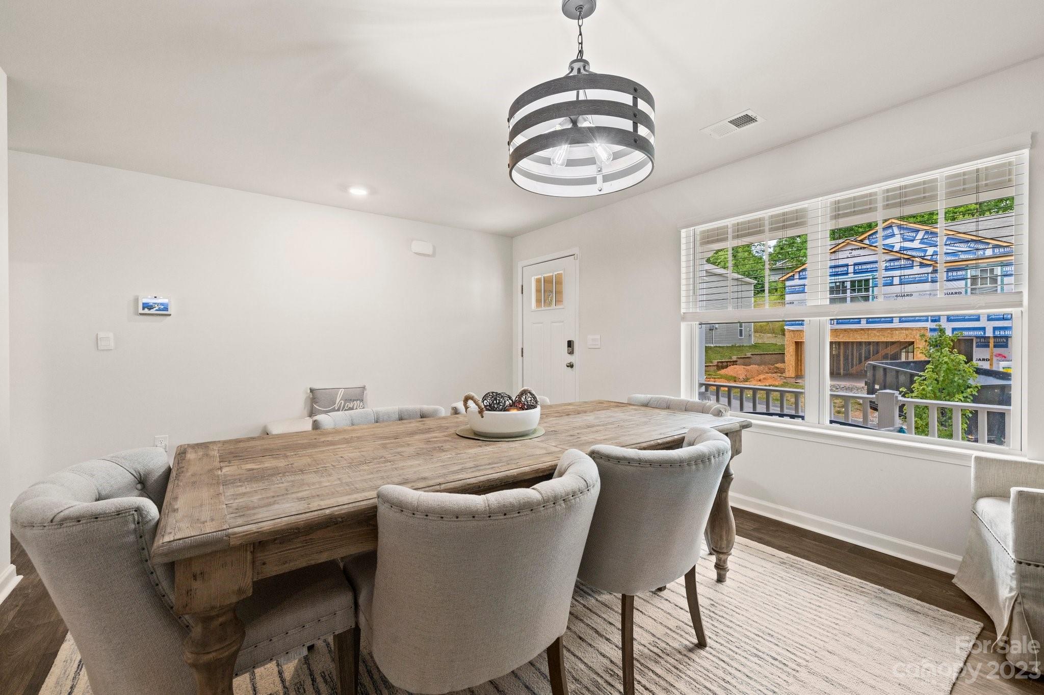 38 Hamrick Drive Candler, NC 28715 - Photo 12 of 37 a view of a dining room with furniture wooden floor and chandelier