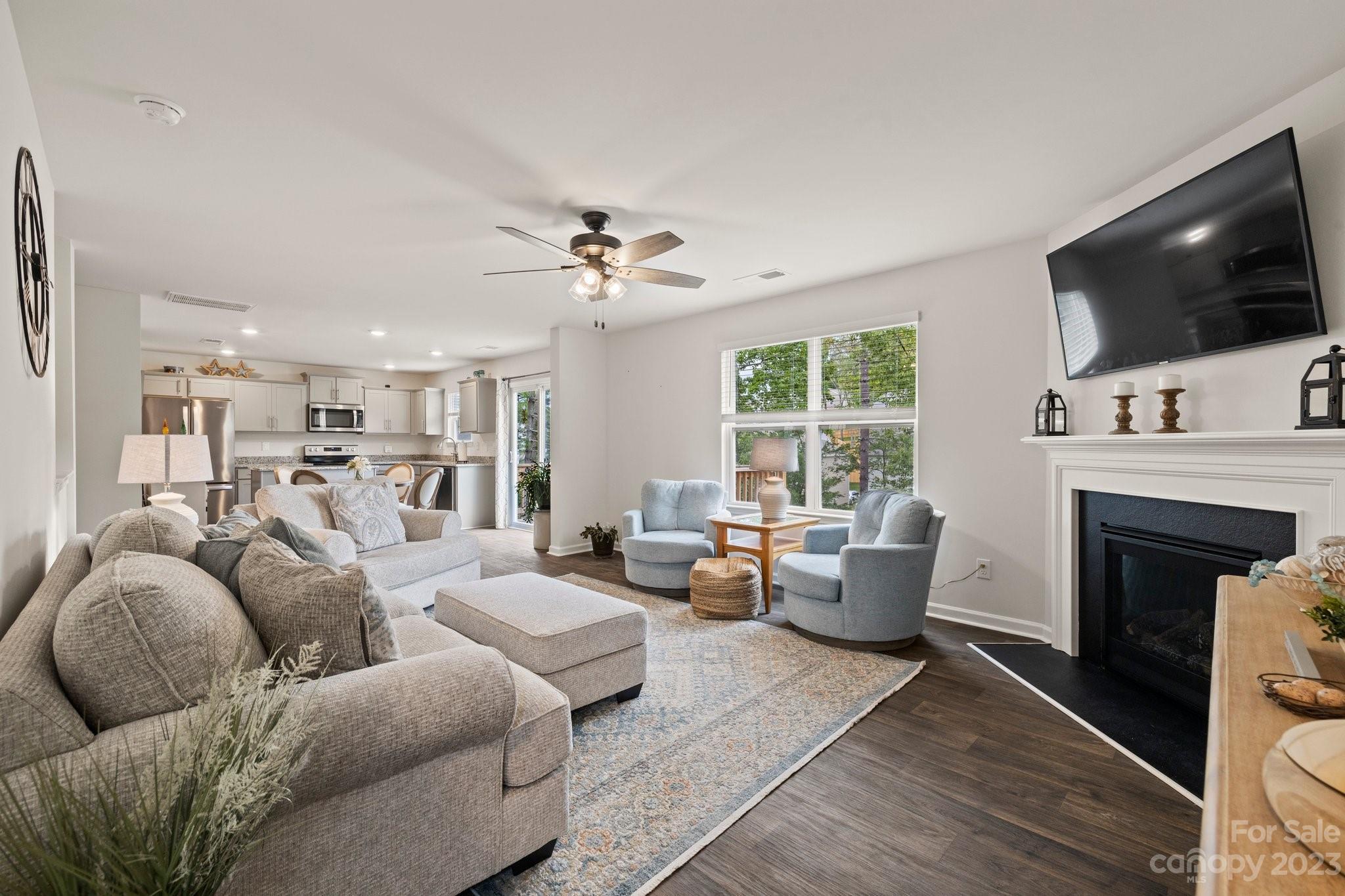 38 Hamrick Drive Candler, NC 28715 - Photo 15 of 37 a living room with furniture a flat screen tv and a fireplace