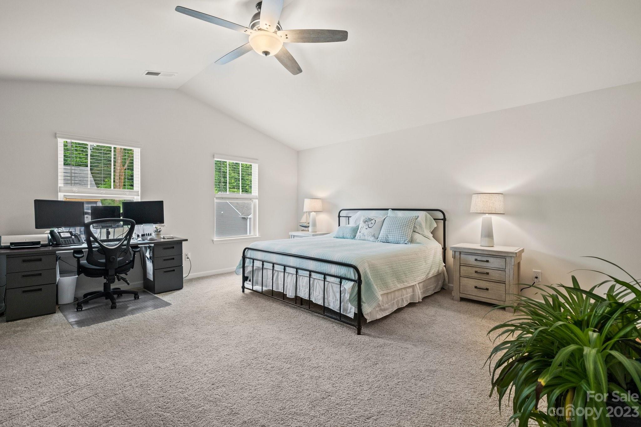 38 Hamrick Drive Candler, NC 28715 - Photo 17 of 37 a spacious bedroom with a bed a table and chair