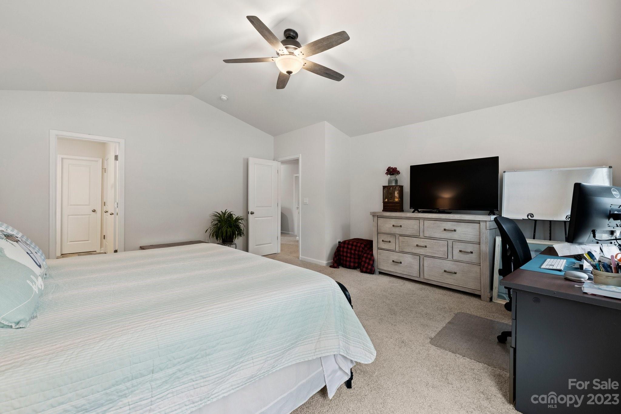 38 Hamrick Drive Candler, NC 28715 - Photo 18 of 37 a bedroom with a bed and a flat tv screen on dresser