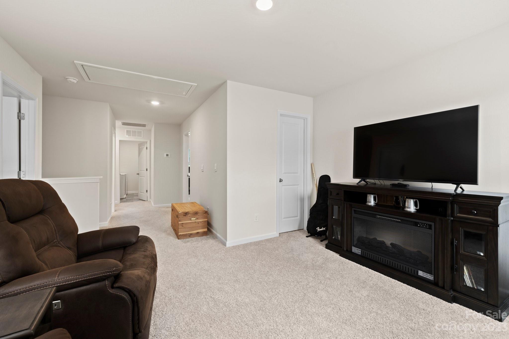 38 Hamrick Drive Candler, NC 28715 - Photo 22 of 37 a living room with furniture and a flat screen tv