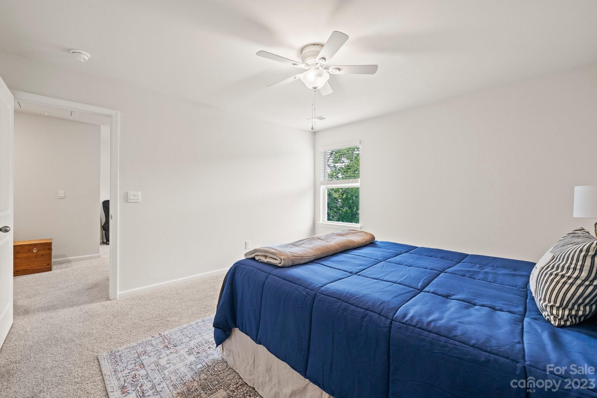 38 Hamrick Drive Candler, NC 28715 - Photo 27 of 37 a bedroom with a large bed and a chandelier