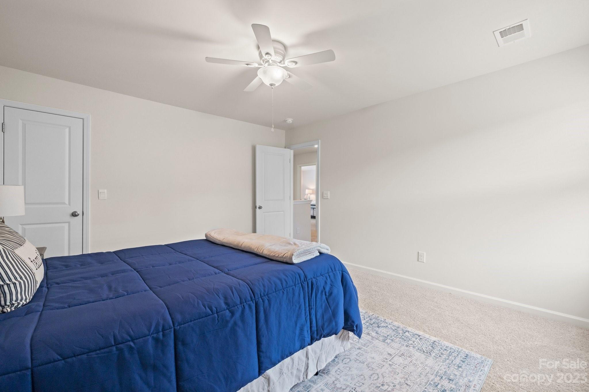 38 Hamrick Drive Candler, NC 28715 - Photo 28 of 37 a bedroom with a large bed and a chandelier