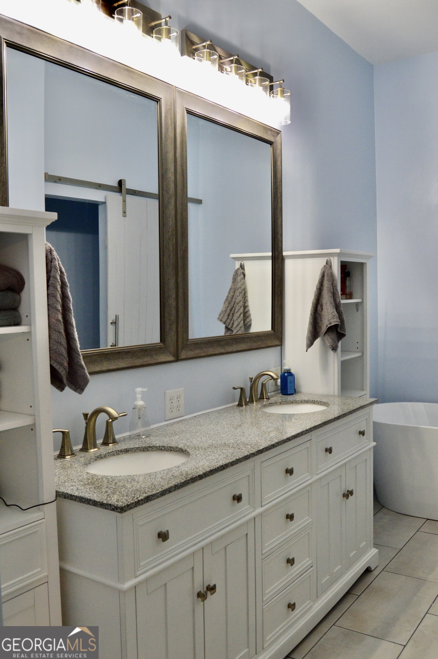 817 Brookside Drive Winder, GA 30680 - Photo 58 of 126 a bathroom with a granite countertop double sink and a mirror