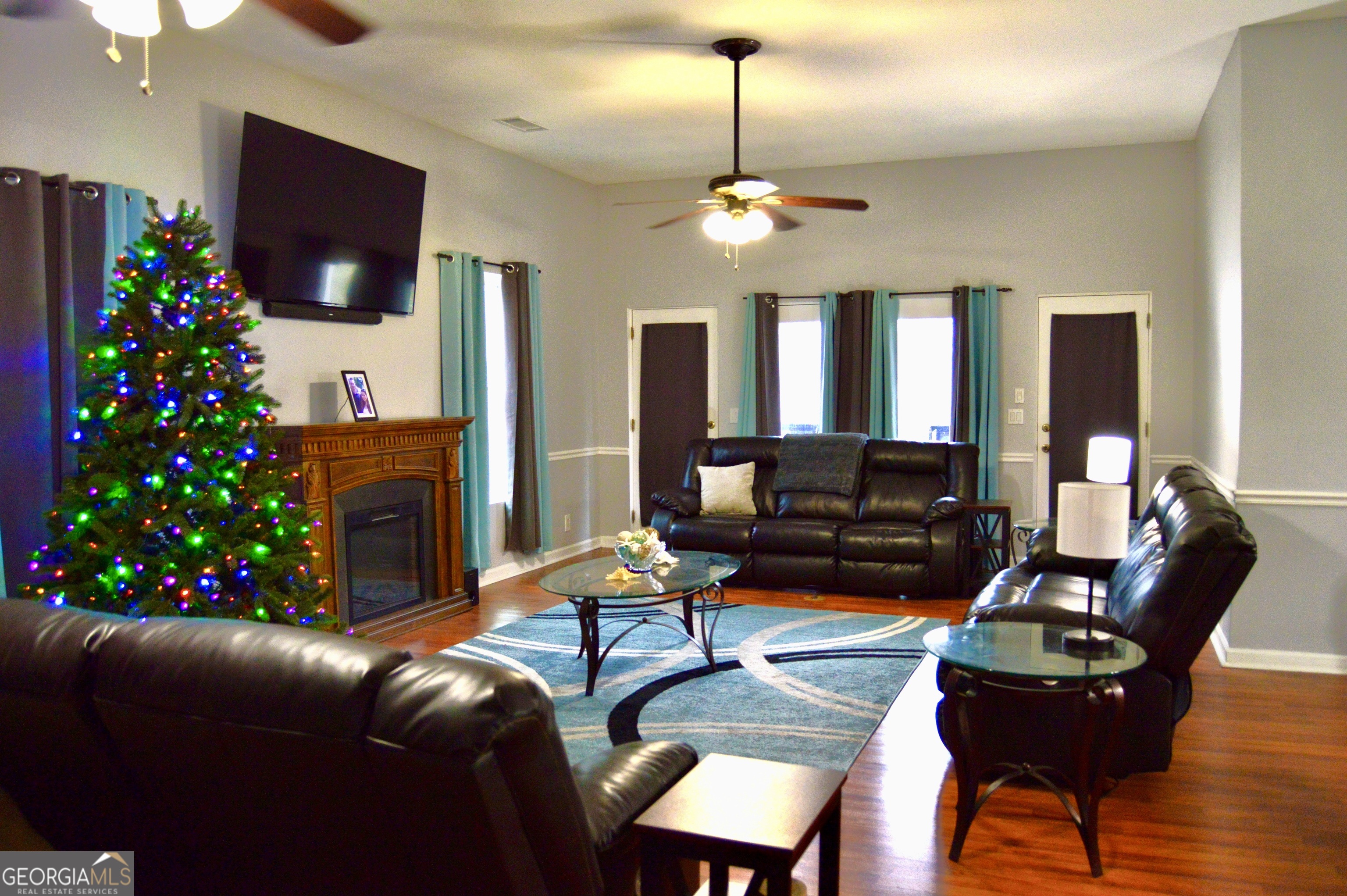 817 Brookside Drive Winder, GA 30680 - Photo 6 of 126 a living room with furniture a flat screen tv and a chandelier