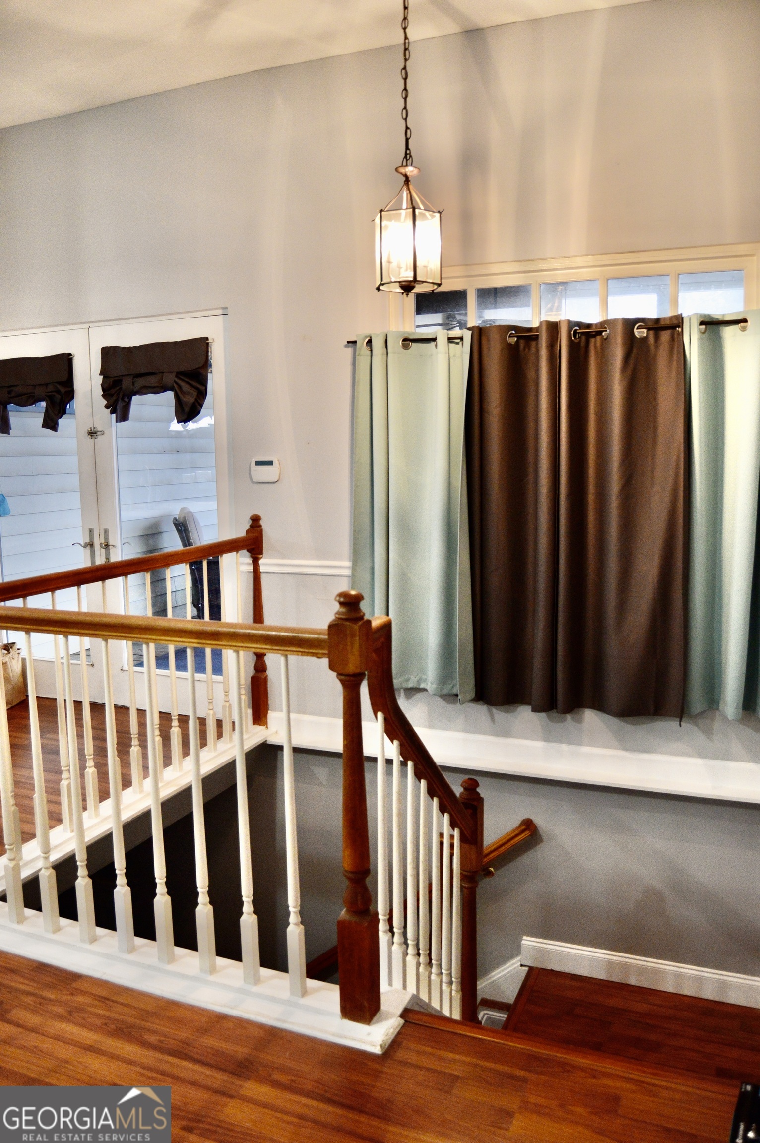 817 Brookside Drive Winder, GA 30680 - Photo 65 of 126 a view of staircase with railing and a chandelier