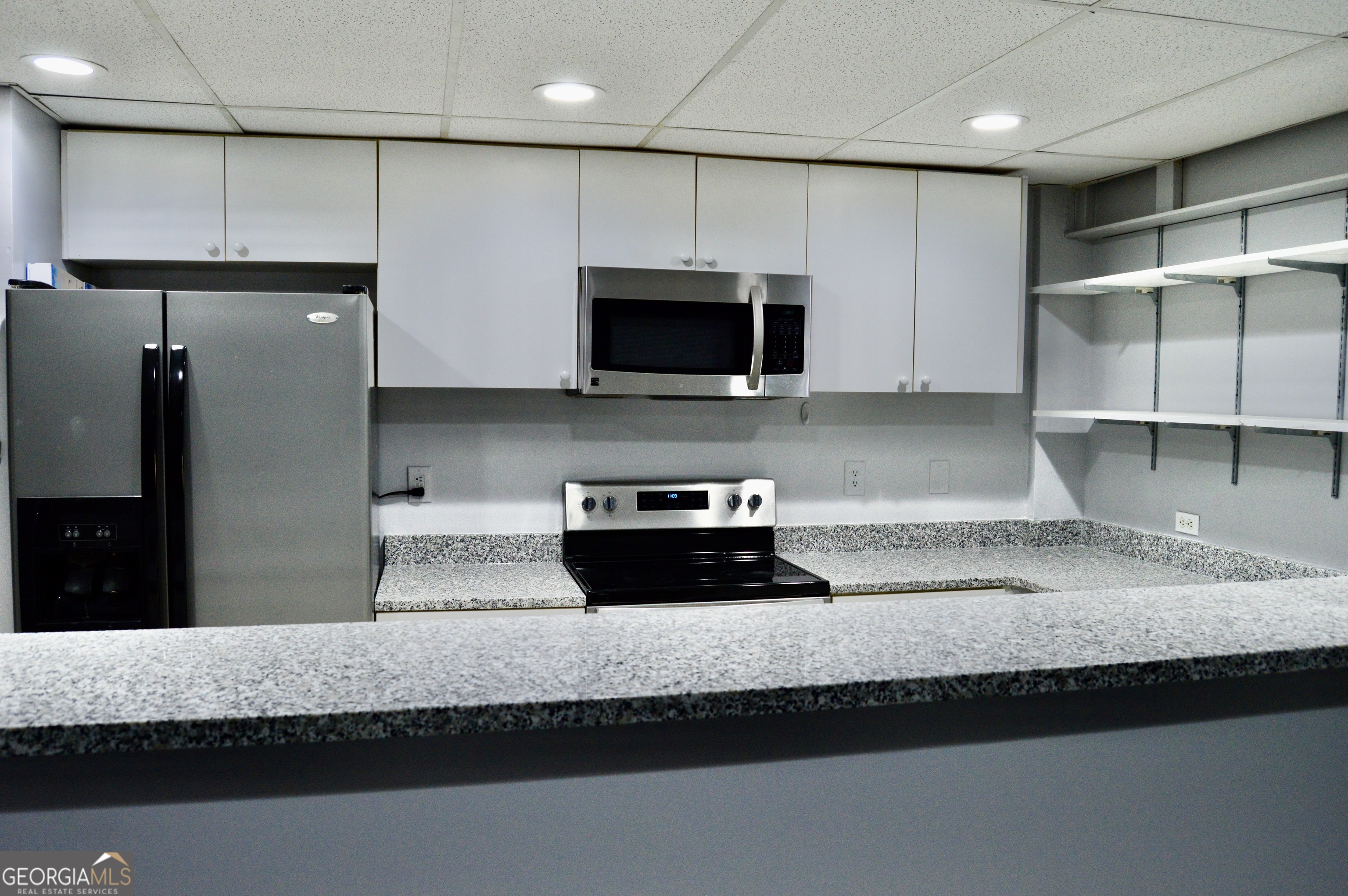 817 Brookside Drive Winder, GA 30680 - Photo 69 of 126 a kitchen with granite countertop white cabinets and stainless steel appliances