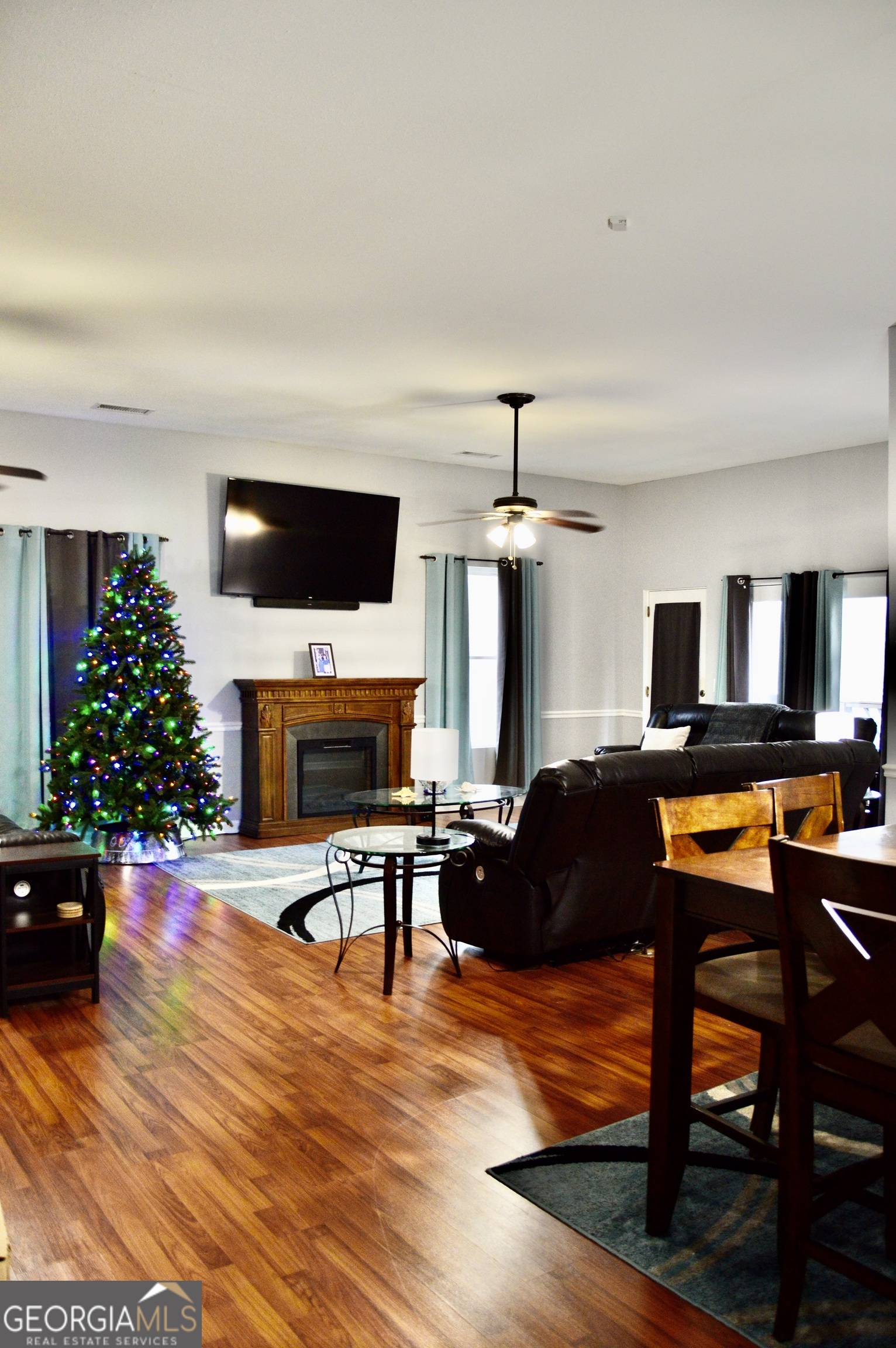 817 Brookside Drive Winder, GA 30680 - Photo 7 of 126 a living room with furniture a fireplace and a flat screen tv