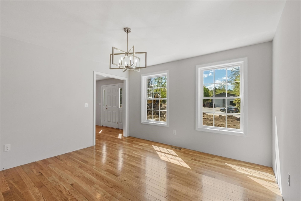 22 Benoit Avenue Pelham, NH 03076 - Photo 21 of 42 a view of an empty room with wooden floor and a window