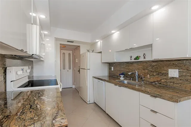 a kitchen with sink and refrigerator
