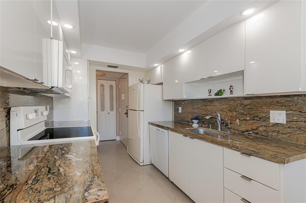 1200 St Charles Place, Unit L19 Pembroke Pines, FL 33026 - Photo 13 of 26 a kitchen with sink and refrigerator