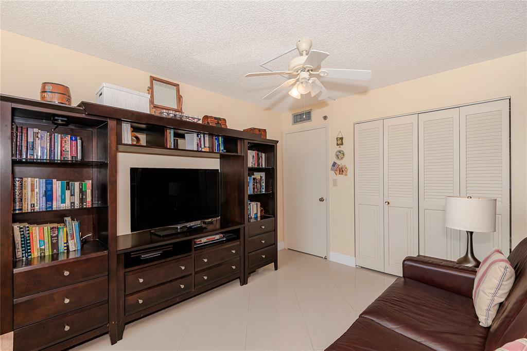 1200 St Charles Place, Unit L19 Pembroke Pines, FL 33026 - Photo 18 of 26 a living room with furniture and a flat screen tv