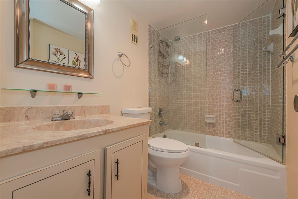 1200 St Charles Place, Unit L19 Pembroke Pines, FL 33026 - Photo 19 of 26 a bathroom with a granite countertop sink toilet and shower