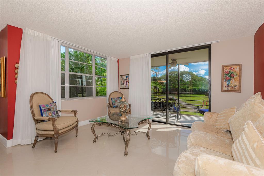 1200 St Charles Place, Unit L19 Pembroke Pines, FL 33026 - Photo 2 of 26 a living room with furniture and a window