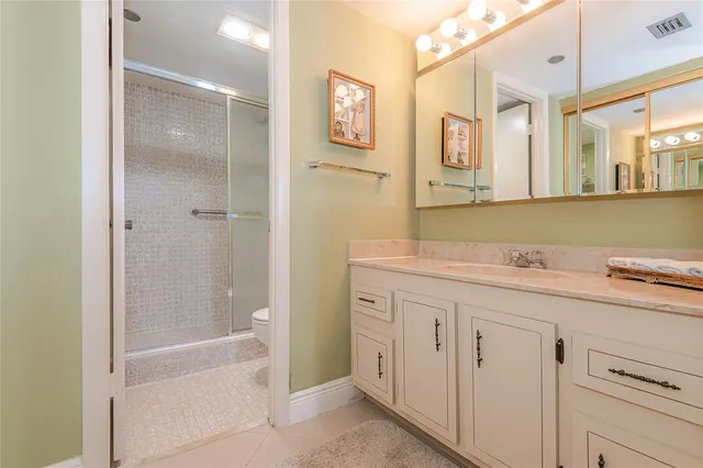 a bathroom with a granite countertop sink mirror and a