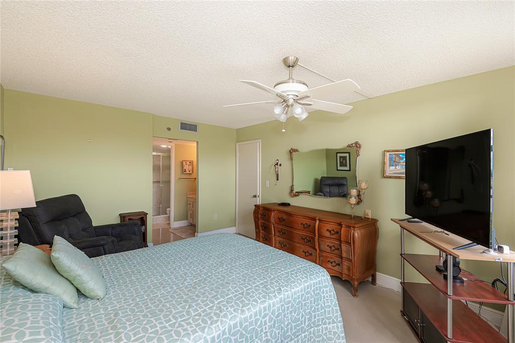 1200 St Charles Place, Unit L19 Pembroke Pines, FL 33026 - Photo 22 of 26 a bedroom with a bed and a flat screen tv