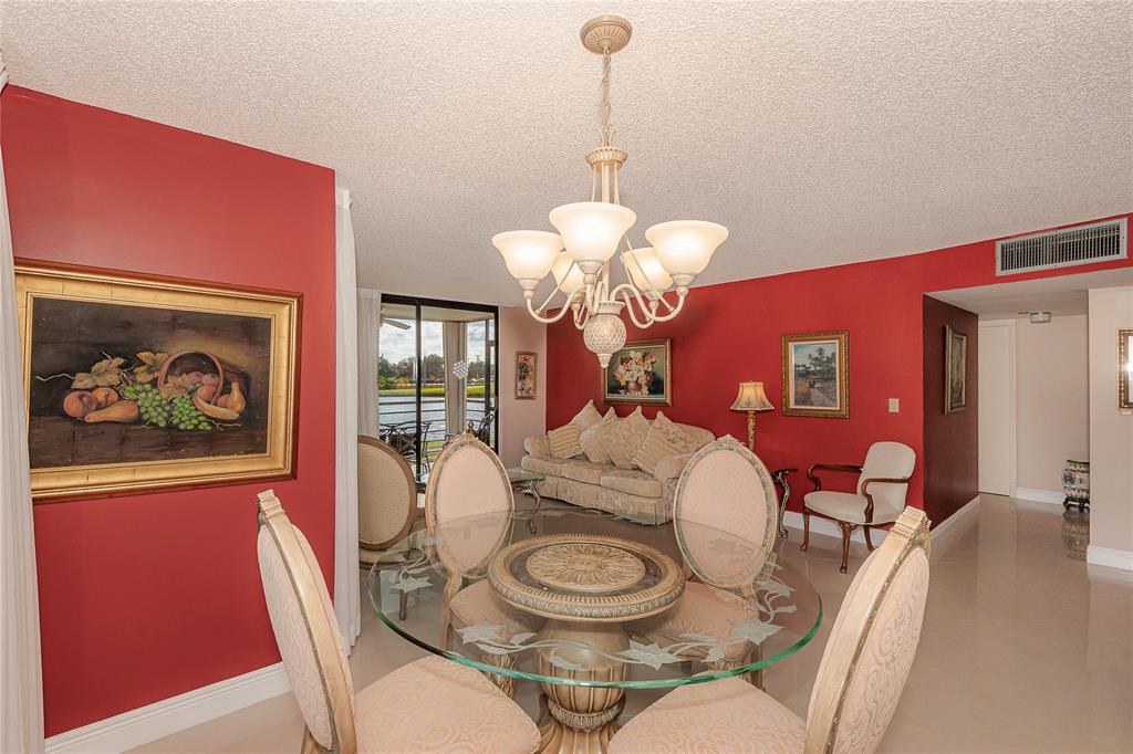 1200 St Charles Place, Unit L19 Pembroke Pines, FL 33026 - Photo 3 of 26 a view of a dining room with furniture and chandelier