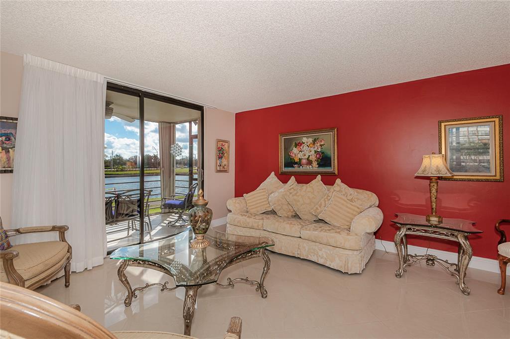 1200 St Charles Place, Unit L19 Pembroke Pines, FL 33026 - Photo 4 of 26 a bedroom with a bed and glass window