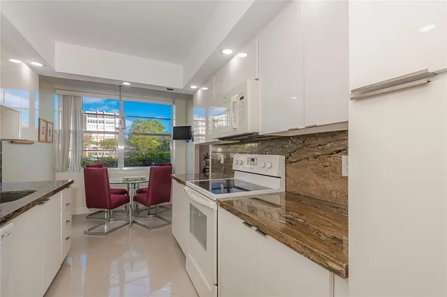 a kitchen with a stove a sink and a refrigerator