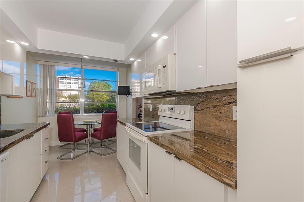 1200 St Charles Place, Unit L19 Pembroke Pines, FL 33026 - Photo 5 of 26 a kitchen with a stove a sink and a refrigerator