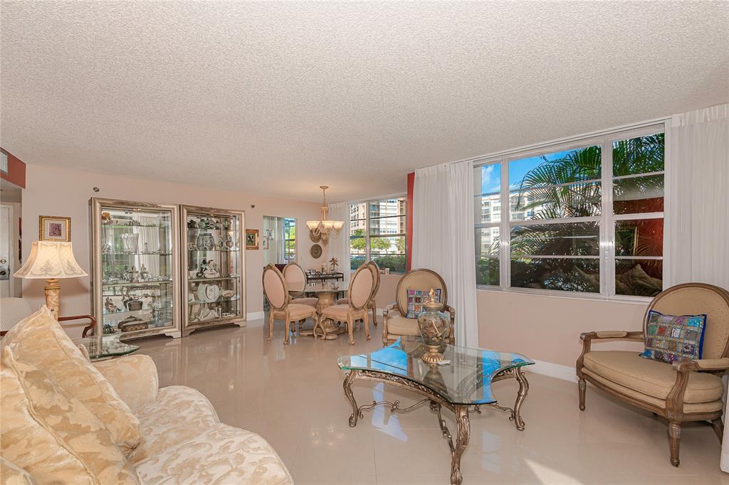 1200 St Charles Place, Unit L19 Pembroke Pines, FL 33026 - Photo 9 of 26 a living room with furniture and a large window