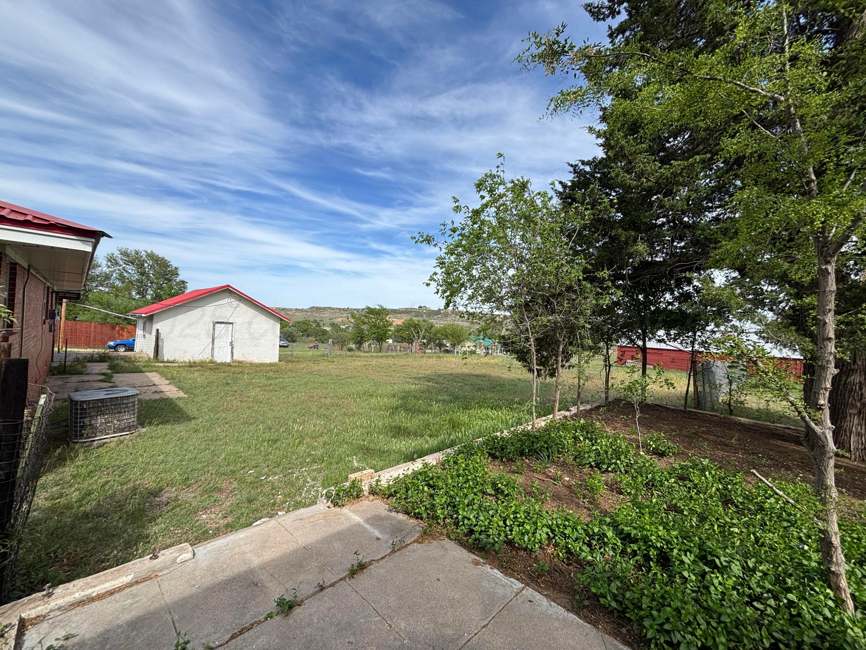 214 East Wichita Street Miami, TX 79059 - Photo 18 of 18 a view of a garden with large trees