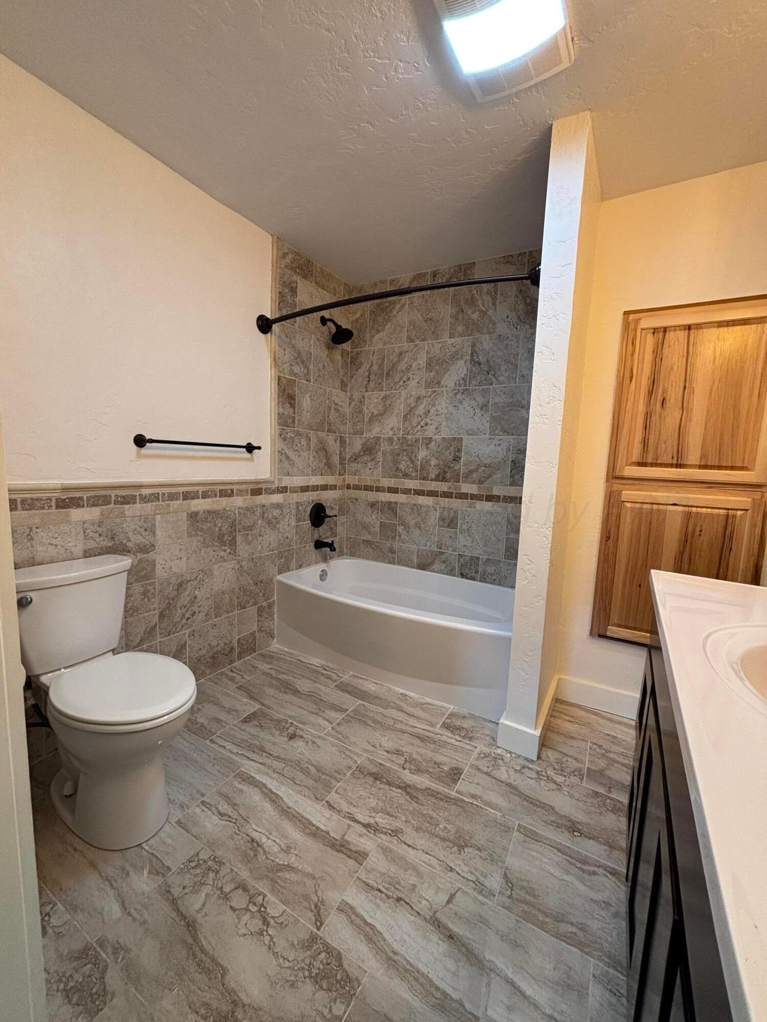 214 East Wichita Street Miami, TX 79059 - Photo 7 of 18 a bathroom with a toilet and a shower