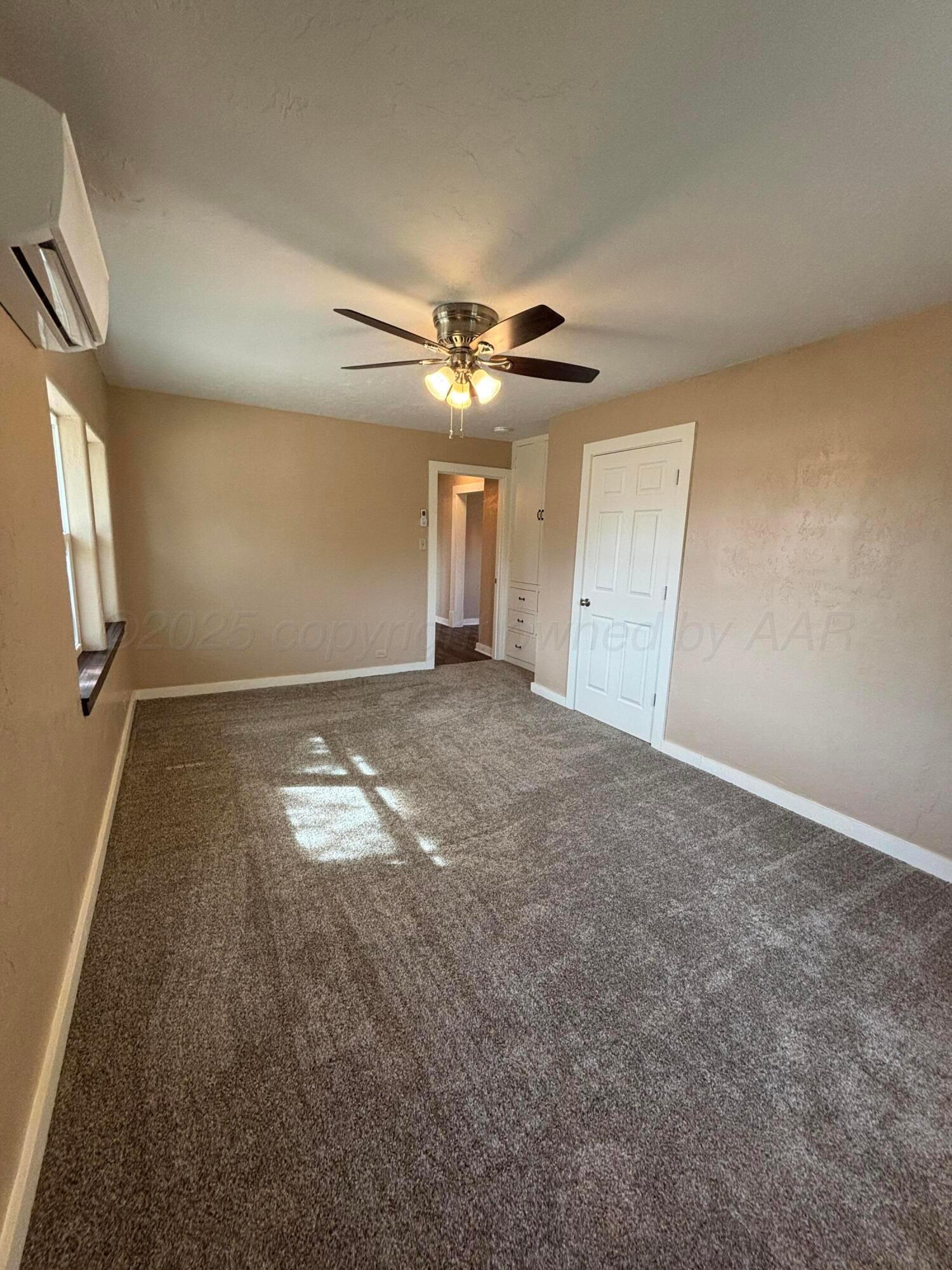 214 East Wichita Street Miami, TX 79059 - Photo 10 of 18 an empty room with a ceiling fan and window