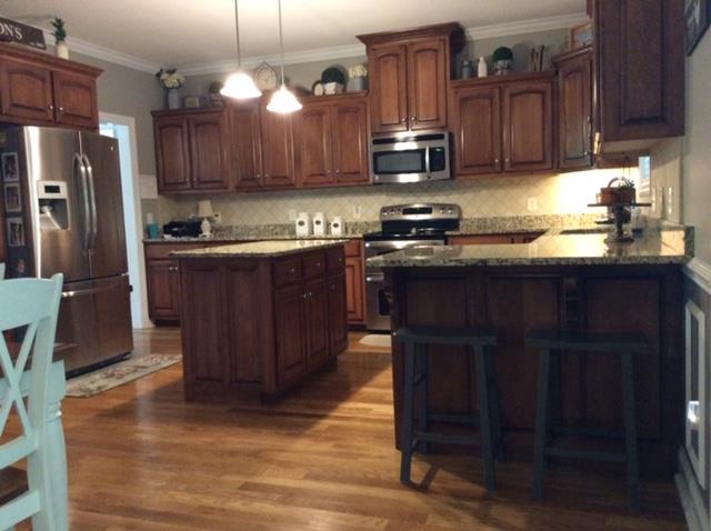 1109 Loftin Road Columbia, TN 38401 - Photo 5 of 18 a kitchen with stainless steel appliances granite countertop wooden cabinets a stove top oven a sink and dishwasher