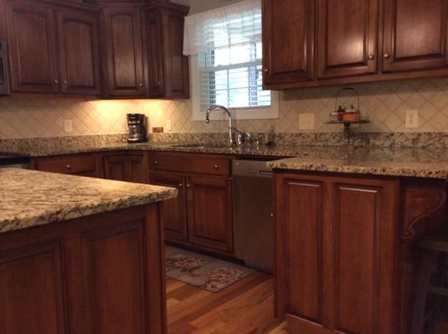 1109 Loftin Road Columbia, TN 38401 - Photo 6 of 18 a kitchen with granite countertop wooden cabinets a sink and dishwasher