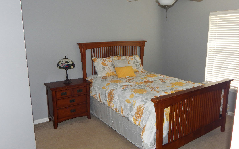 96784 Blackrock Road Yulee, FL 32097 - Photo 8 of 11 a bed sitting in a bedroom next to a window