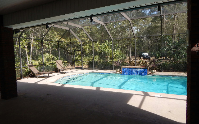 96784 Blackrock Road Yulee, FL 32097 - Photo 10 of 11 a backyard of a house with barbeque oven table and chairs