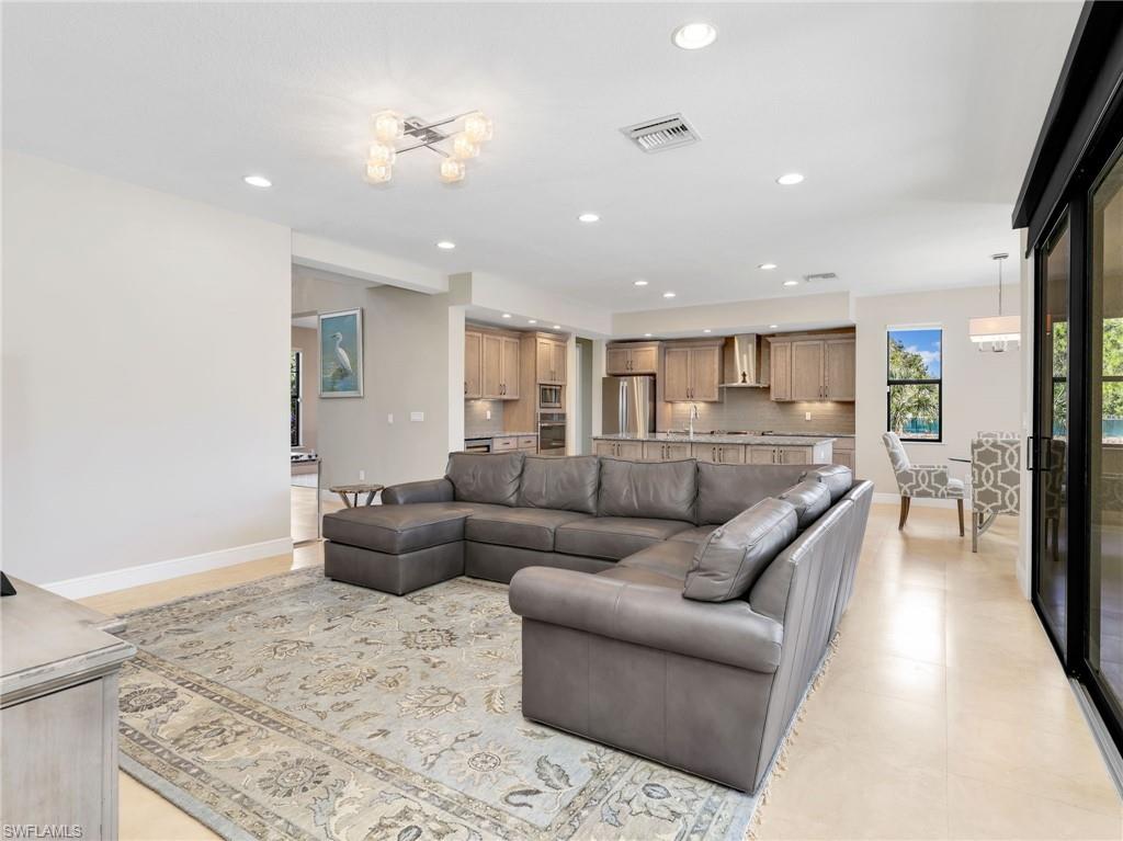 3160 27th Avenue Southwest Naples, FL 34117 - Photo 17 of 43 a living room with furniture and a view of kitchen