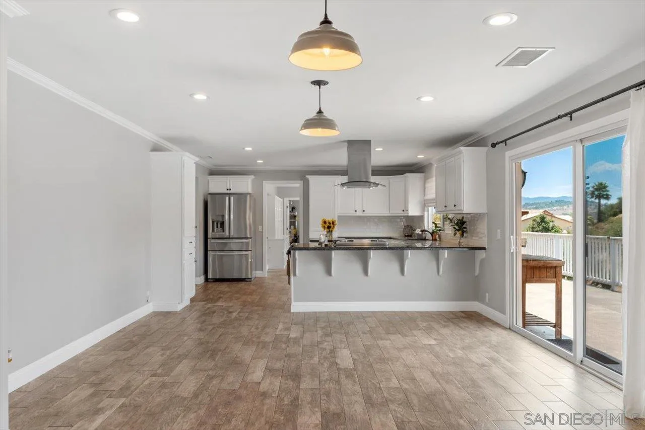 32251 Cole Grade Road Valley Center, CA 92082 - Photo 14 of 54 a open kitchen with white cabinets and stainless steel appliances