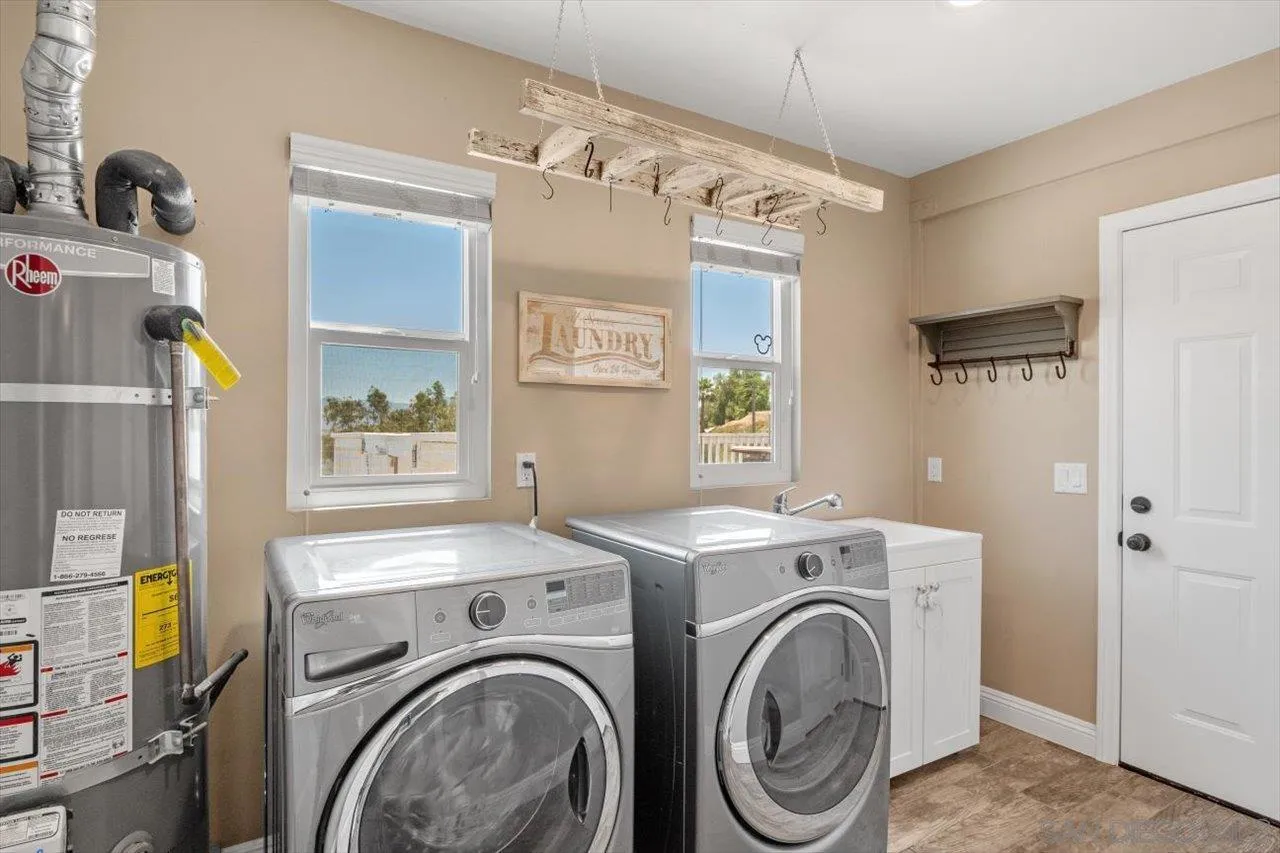 32251 Cole Grade Road Valley Center, CA 92082 - Photo 16 of 54 a view of storage and utility room with washer and dryer