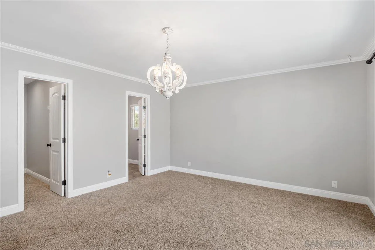 32251 Cole Grade Road Valley Center, CA 92082 - Photo 20 of 54 a view of an empty room with a chandelier fan