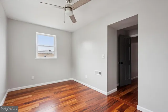 a view of a room with wooden floor and closet