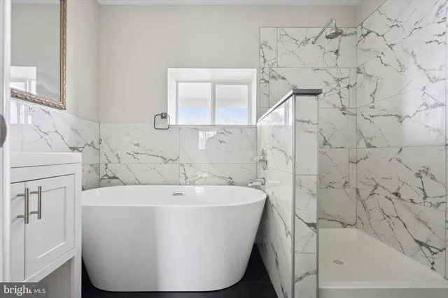 a white bath tub sitting in a bathroom
