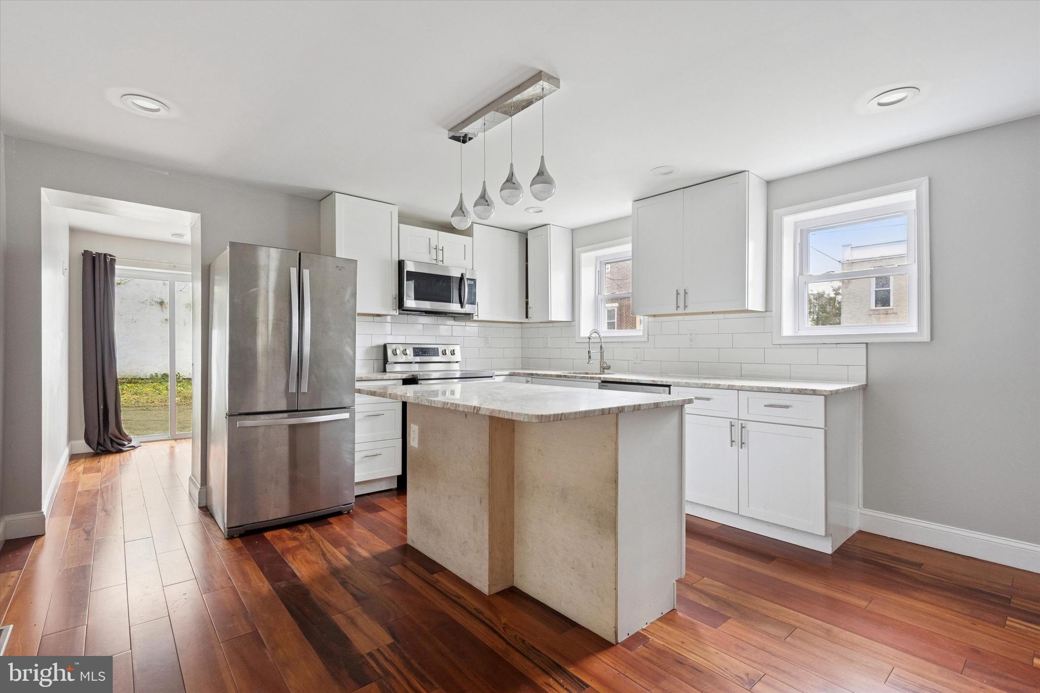 213 East Phil Ellena Street Philadelphia, PA 19119 - Photo 6 of 28 a kitchen with kitchen island granite countertop appliances cabinets a sink and a center island