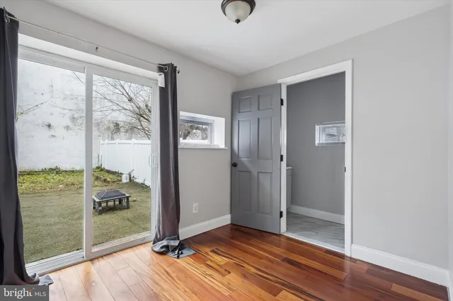 a view of a room with wooden floor and front door