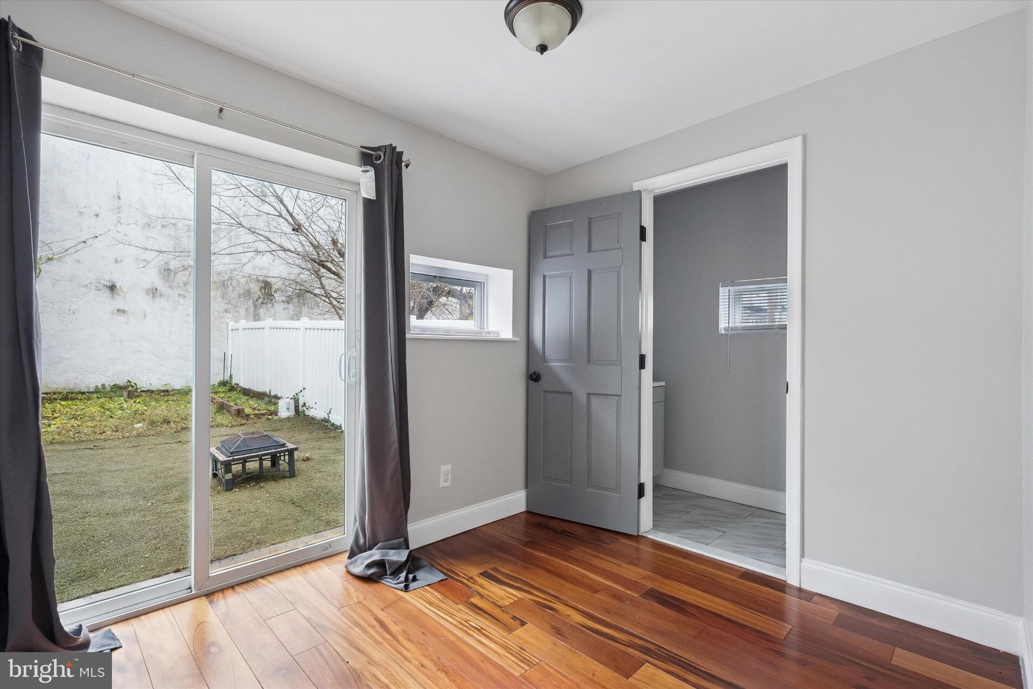 213 East Phil Ellena Street Philadelphia, PA 19119 - Photo 10 of 28 a view of a room with wooden floor and front door