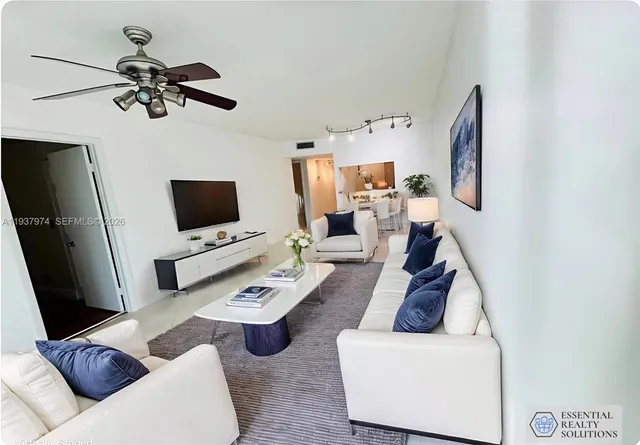 a bedroom with a bed a mirror on desk and a window