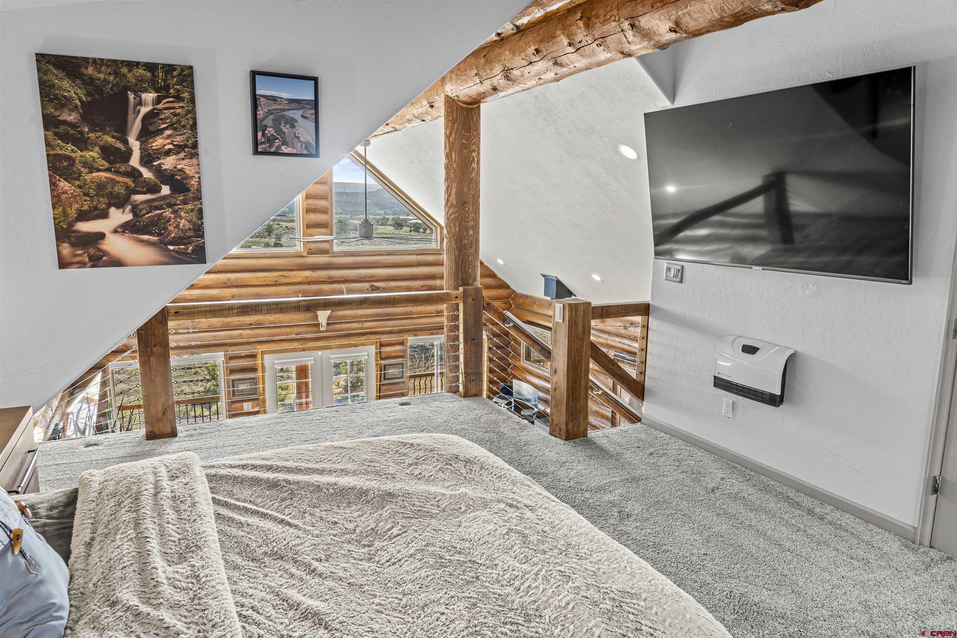 70848 Buckhorn Road Montrose, CO 81403 - Photo 19 of 43 a bedroom with furniture and a flat screen tv